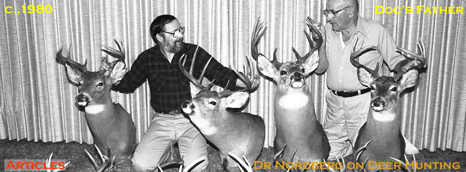 Photo of Doc posing with a large collection of buck mounts and his father John Nordberg from about 1980