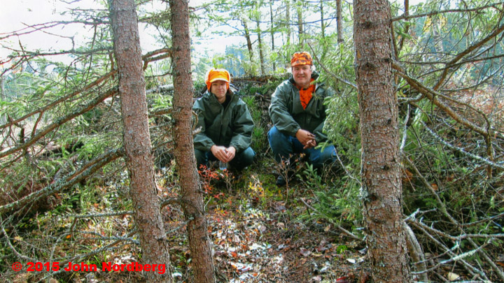 Doc's son and grandson posing in a u-shaped ground blind.