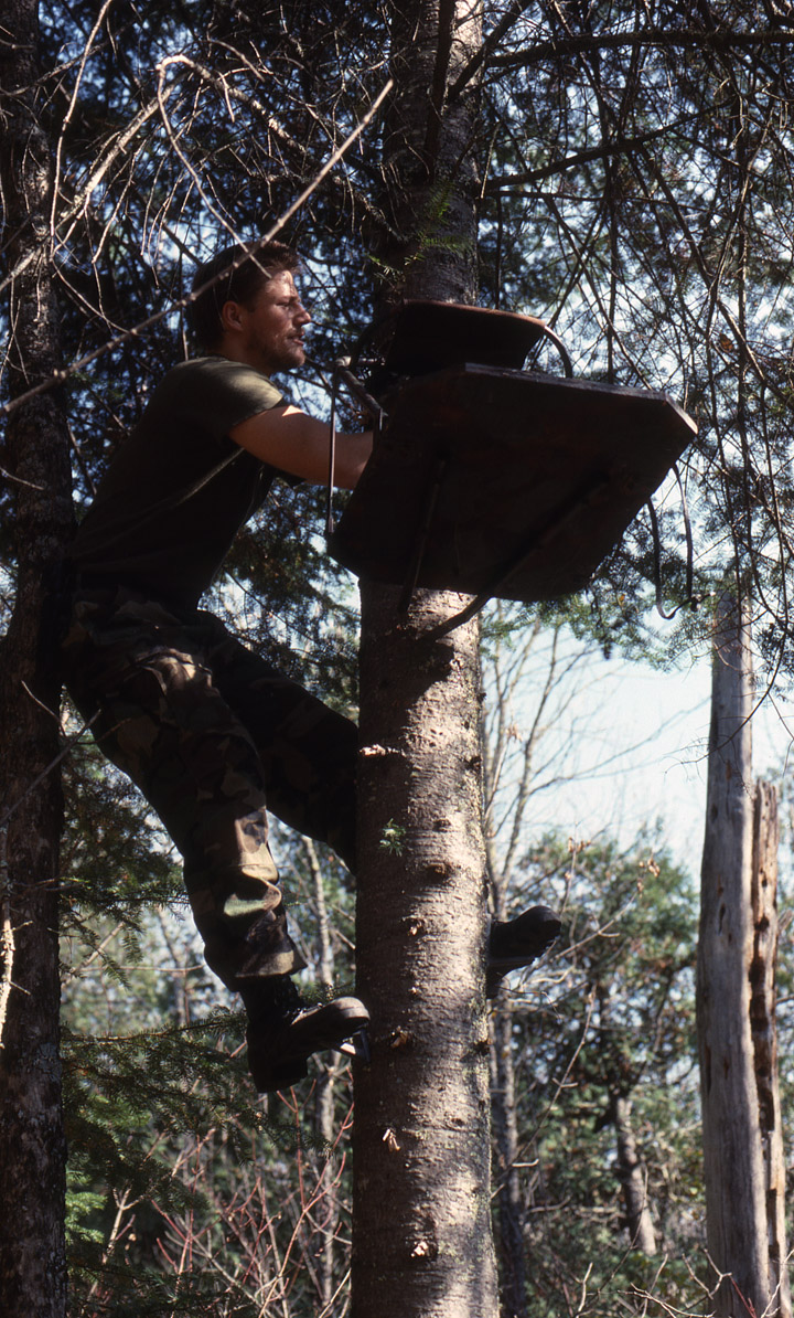 Doc's son Ken hanging a tree stand.